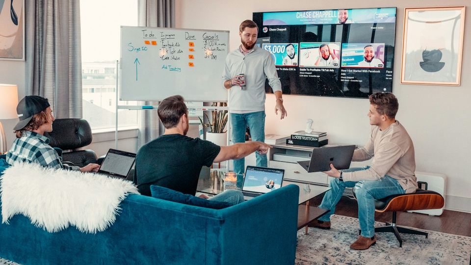 A software team working together around a shared dashboard